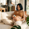 Mother Mother Balm (2 oz) - product shown being applied on pregnant women's stomach. 