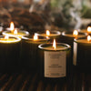 Flamingo Estate Adriatic Muscatel Sage Candle (226 g) - product shown lit in front of lots of other candles.