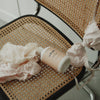 Kerzon Laundry Soap - Maille Caline (500 ml) - product shown on wicker chair with linens. 