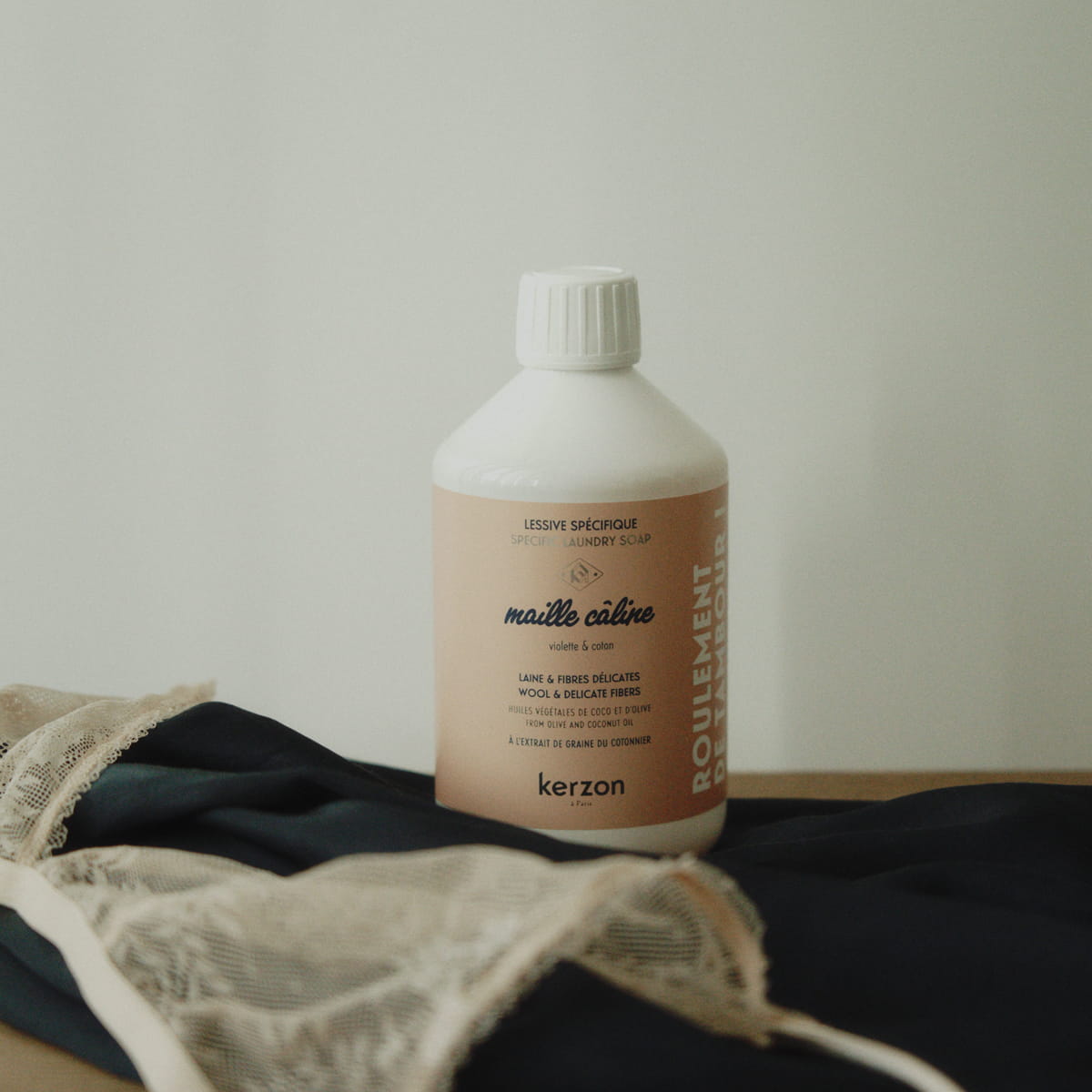 Kerzon Laundry Soap - Maille Caline (500 ml) - product shown on top of linens.