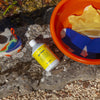 Kerzon Laundry Soap - Gym Tonique (500 ml) - product shown on rock with red bucket and shoes. 