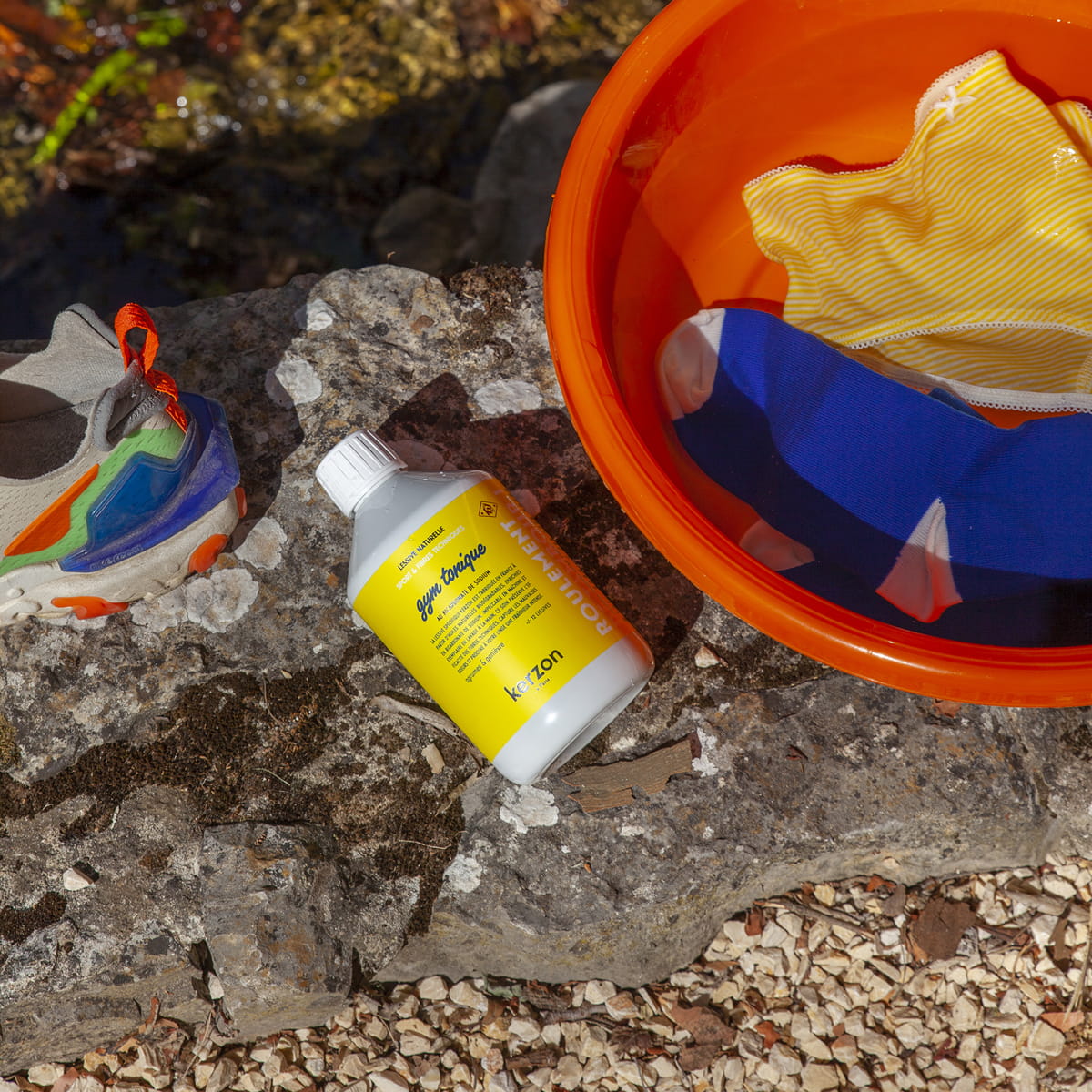 Kerzon Laundry Soap - Gym Tonique (500 ml) - product shown on rock with red bucket and shoes. 
