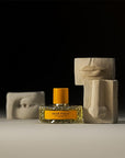 Vilhelm Parfumerie Dear Polly Eau de Parfum - product shown next to ceramic castings of nose, mouth, and eye