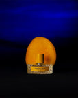 Vilhelm Parfumerie Mango Skin Eau de Parfum - product shown in front of mango on blue background