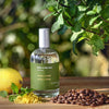 Miller et Bertaux Menta y Menta Eau de Parfum (100 ml) lifestyle shot with lemon, mint and coffee beans in the background