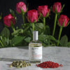 Miller et Bertaux Shanti Eau de Parfum (100 ml) lifestyle shot with red roses and ingredients in the background