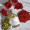 Miller et Bertaux Shanti Eau de Parfum (100 ml) lifestyle shot with red roses and ingredients in the background