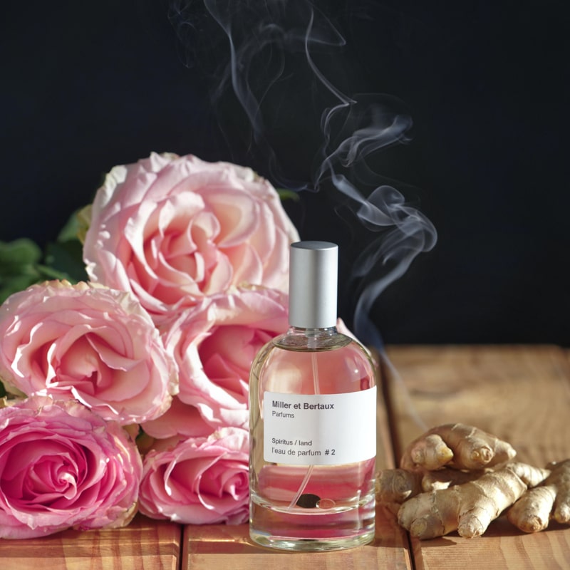 Miller et Bertaux #2 Eau de Parfum (100 ml) lifestyle shot with pink roses and ginger in the background
