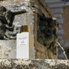 Lifestyle shot of Eau d'Italie Eau de Parfum Spray (100 ml) with stone fountain in the background