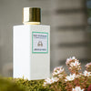 Lifestyle shot of Eau d'Italie Jardin du Poete Eau de Parfum Spray (100 ml) with flowers in the foreground