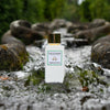 Lifestyle shot of Eau d'Italie Jardin du Poete Eau de Parfum Spray (100 ml) in the middle of stream with water cascading around the sides