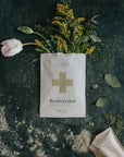 Pursoma Resurrection - Detox bag open with flowers coming out on the ground