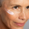 Close up of Odacite Creme de la Nuit applied to woman's face with mature skin