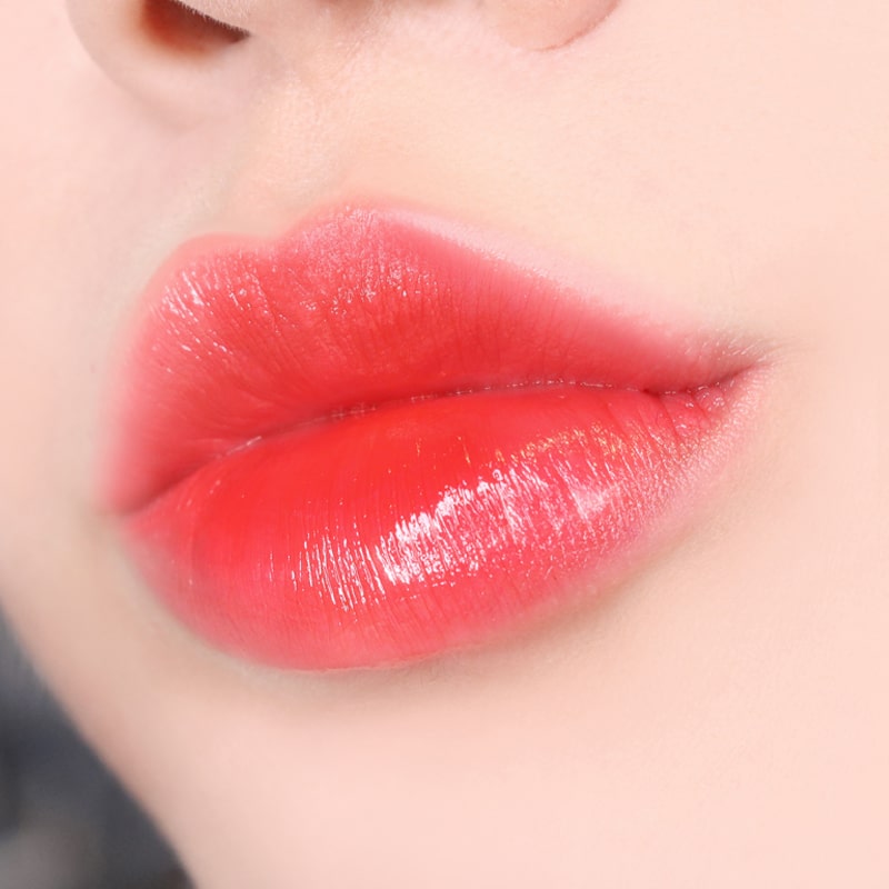 Paul + Joe Liquid Rouge Shine (0.28 oz, Red Stilettos (01)) on model&#39;s lips