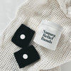 Mother Mother Morning Sickness Relief Bands (1 pr) - product shown on fabric next to packaging. 