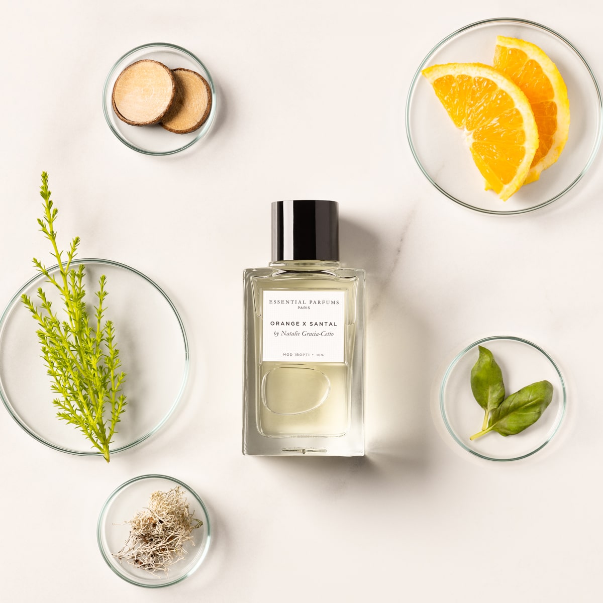 Essential Parfums Orange X Santal Perfume by Natalie Gracia Cetto - Refillable - product shown on white background with bowls of ingredients.