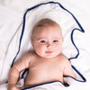 Malabar Baby Luxe Silky Soft Bamboo Cotton Swaddle – Navy Pom Pom Trim shown wrapped around baby