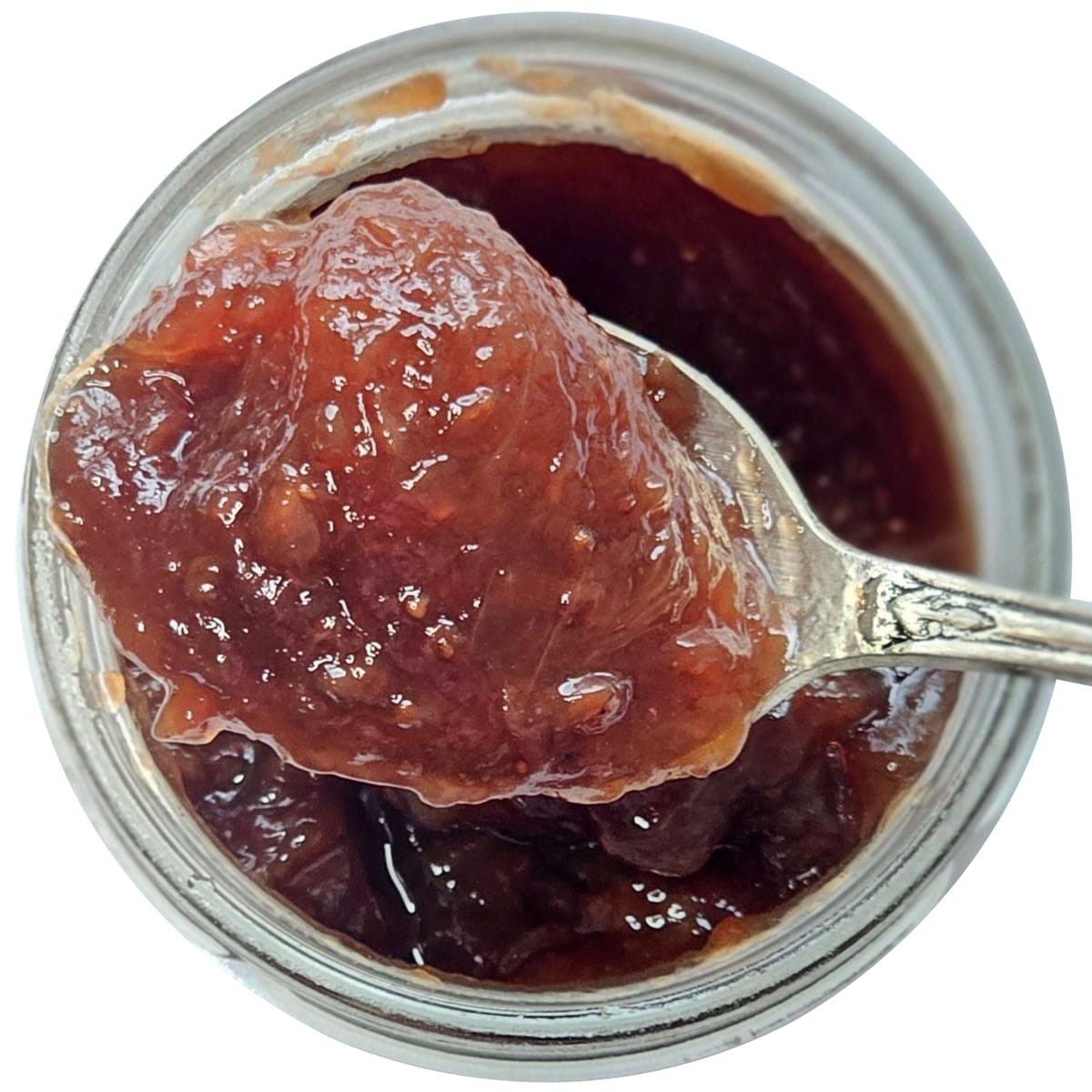 Top view of opened jar of Confiture Parisienne Strawberry Raspberry Rose Geranium (8.8 oz) with jam on spoon
