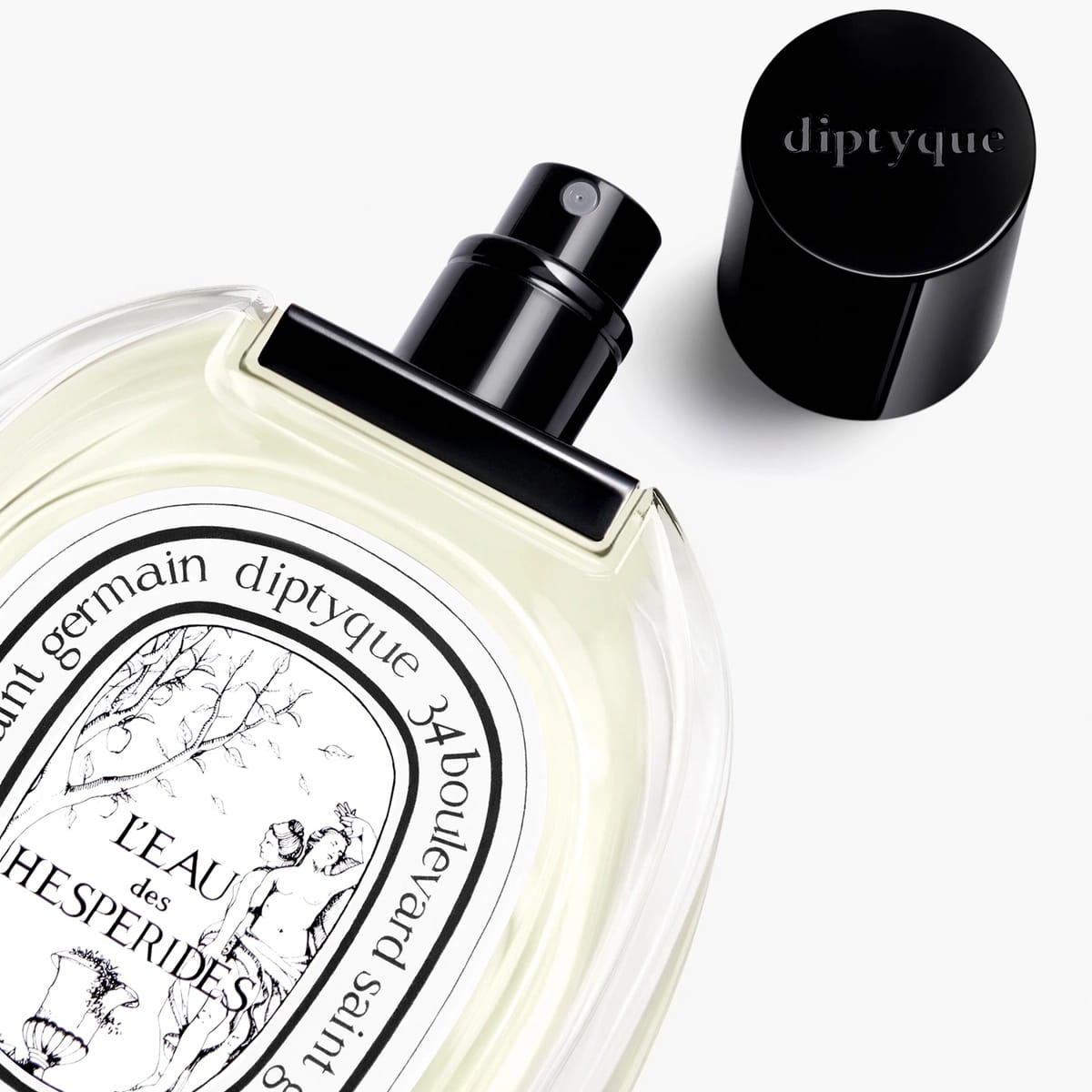 Diptyque L’Eau des Hesperides Eau de Toilette (100 ml) - product shown on laying on counter with lid off. 