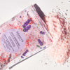 Close up top view of Odacite Soul Soothing Relaxing Bath Soak (8 oz) shown open with bath soak spilling out of pouch
