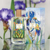 Lifestyle shot of Fragonard Parfumeur Belle de Paris Eau de Toilette (100 ml) with box, and purple iris flowers in the background.