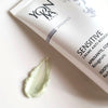 Close up of top view of Yon-Ka Paris Sensitive Creme Anti-Redness (50 ml) with smear of product to show green color and texture