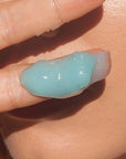Odacite Le Blue Balm showing finger with balm 