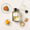 Fig Infusion by Nathalie Lorson (100 ml) - Product shown with flowers, fruit and wood.