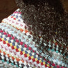 Close up of model with Bathing Culture Cosmic Rainbow Towel (Deadstock) over shoulders