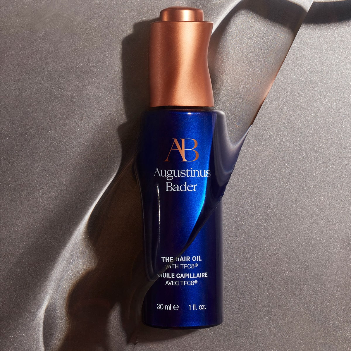 Augustinus Bader The Hair Oil (30 ml) - product shown with water on it