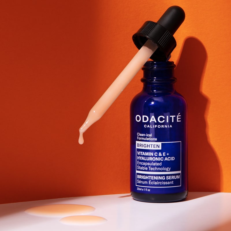 Lifestyle shot of Odacite Vitamin C & E + Hyaluronic Acid Brightening Serum bottle with dropper 