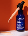 Lifestyle shot of Odacite Vitamin C & E + Hyaluronic Acid Brightening Serum bottle with dropper 