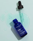 Odacite Salicylic + Hyaluronic Acid Clarifying Serum with dropper and serum in the background