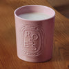 Diptyque Candle Roses (600 g) - product shown on wooden counter top. 