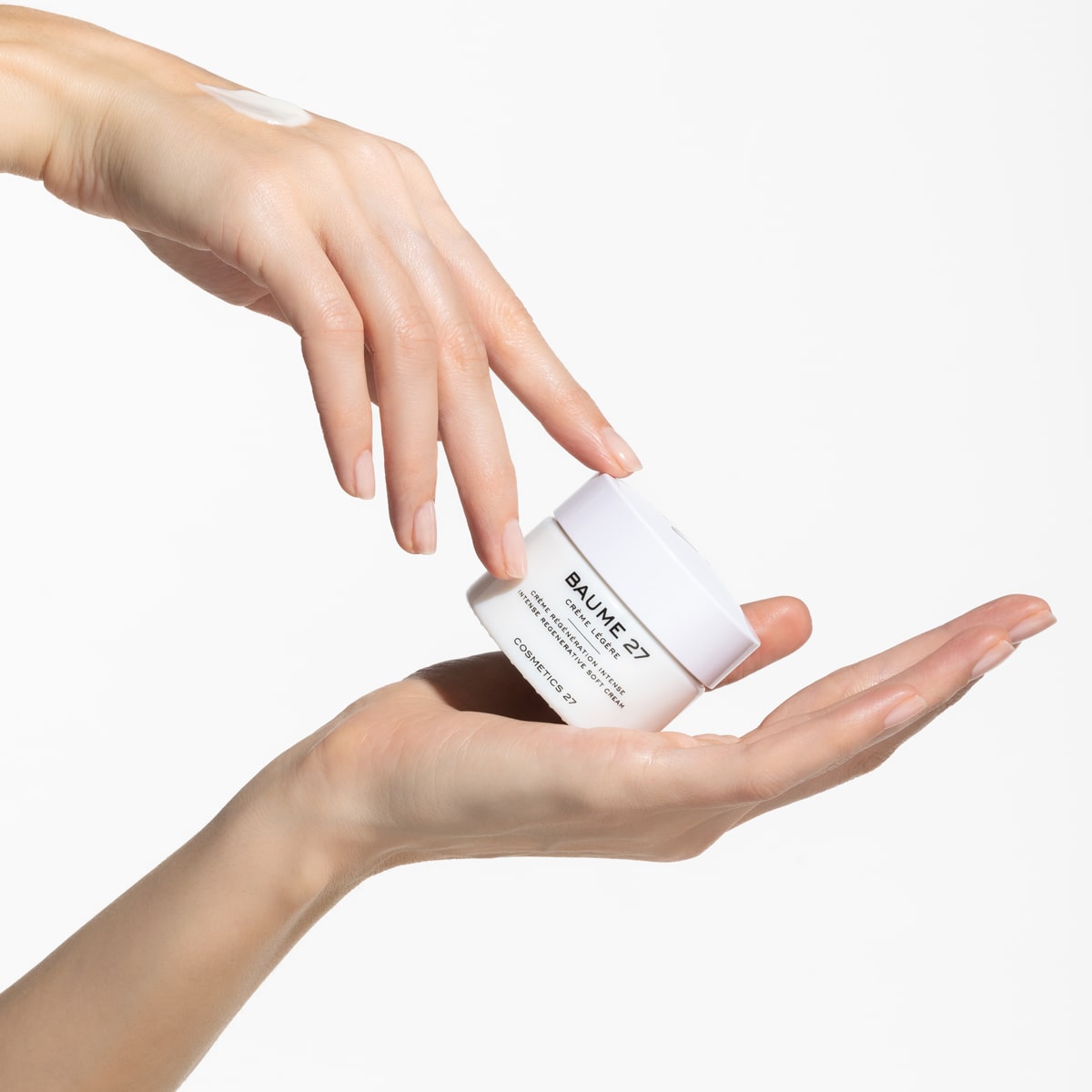 Baume 27 Crème Légère Intense Regenerative Soft Cream (50 ml) - product shown in hands. 