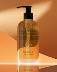 Lifestyle shot of Eau d'Italie Signature Scent Liquid Soap (300 ml) with orange paper in the background