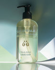 Lifestyle shot of Eau d'Italie Tea & Rose Liquid Soap (300 ml) with green and blue paper in the background