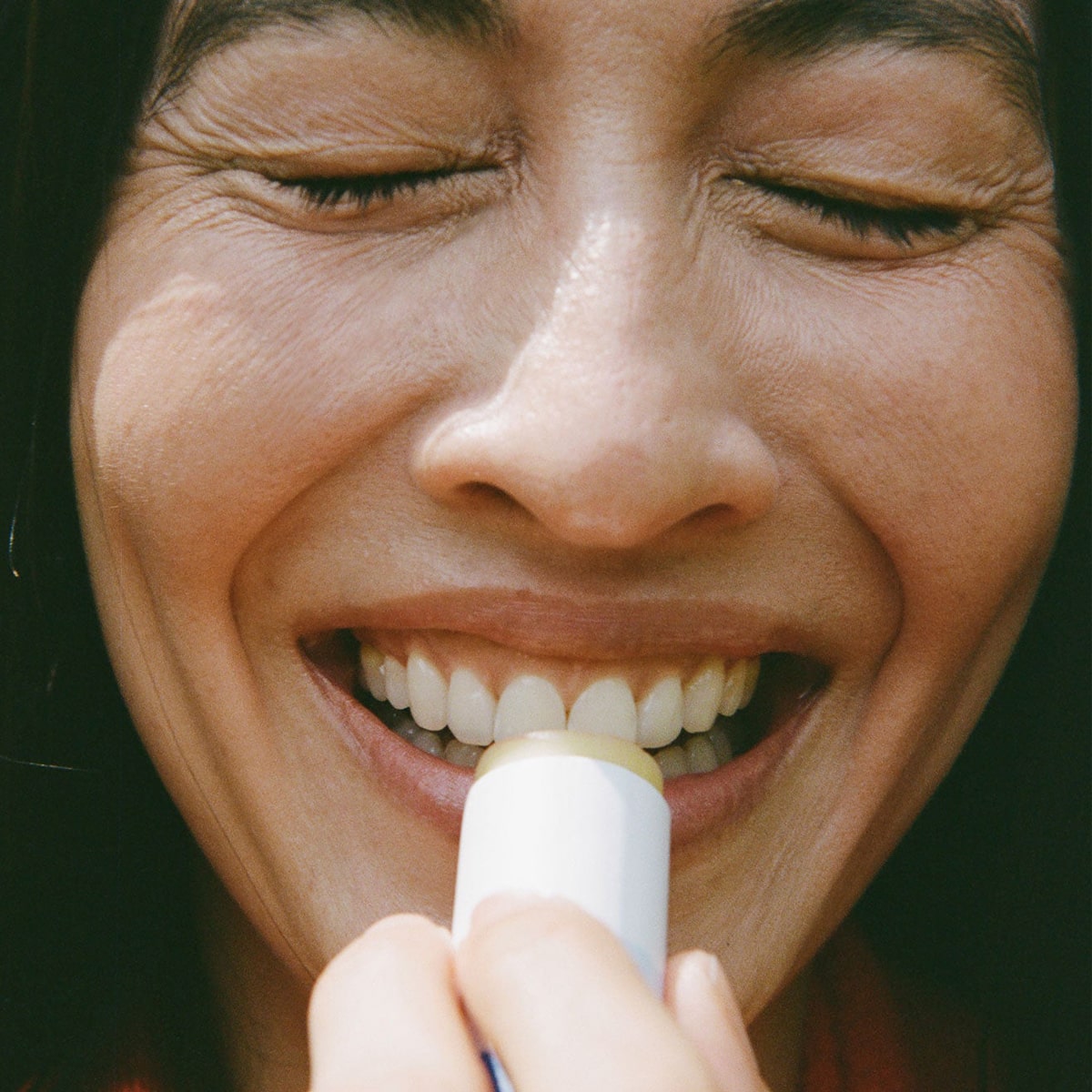 Ursa Major Going Places Lip Balm (0.5 oz) - person applying product