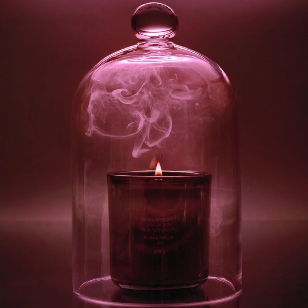 Flamingo Estate Jasmine &amp; Damask Rose Candle (226 g) - product shown on pink background with smoke and glass jar.