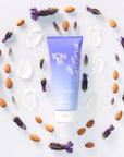 Lifestyle shot top view of Yon-Ka Paris Lait Hydratant Detox – Lavender with almonds, lavender and cream swatches circling around tube
