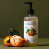 Lifestyle shot of Koala Eco Natural Fruit and Vege Wash - Mandarin (16.9 oz) with mandarin peeled in the foreground