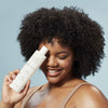 Innersense Organic Beauty Clarity Hairbath (10 oz). - product shown being held by model.