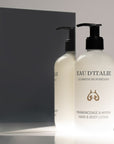 Lifestyle shot of Eau d’Italie Frankincense & Myrrh Hand & Body Lotion (300 ml) in front of mirror with dark gray background reflection