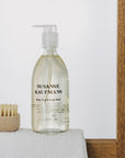 Susanne Kaufmann Body, Face & Scalp Wash - Product displayed on table with towel and brush