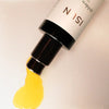 Close up of ISUN Golden Sun Body Oil (100 ml) showing product swatch