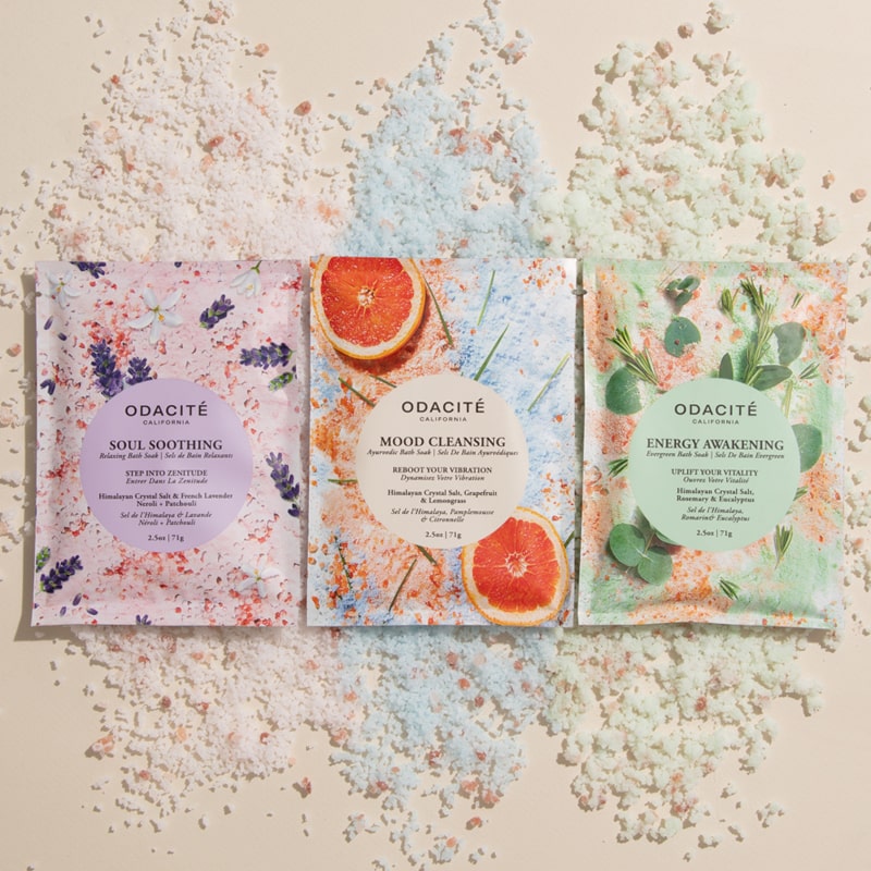 Odacite Soak In Zenitude Bath Soak Trio Set - Products shown with bath soak salts in the background for each variety in the set
