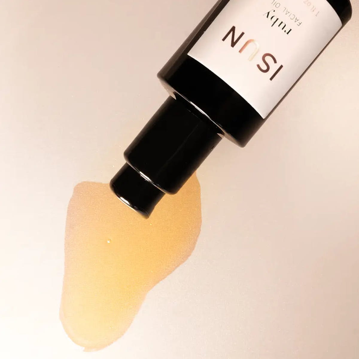 Close up of ISUN Ruby Facial Oil (30 ml) showing product swatch