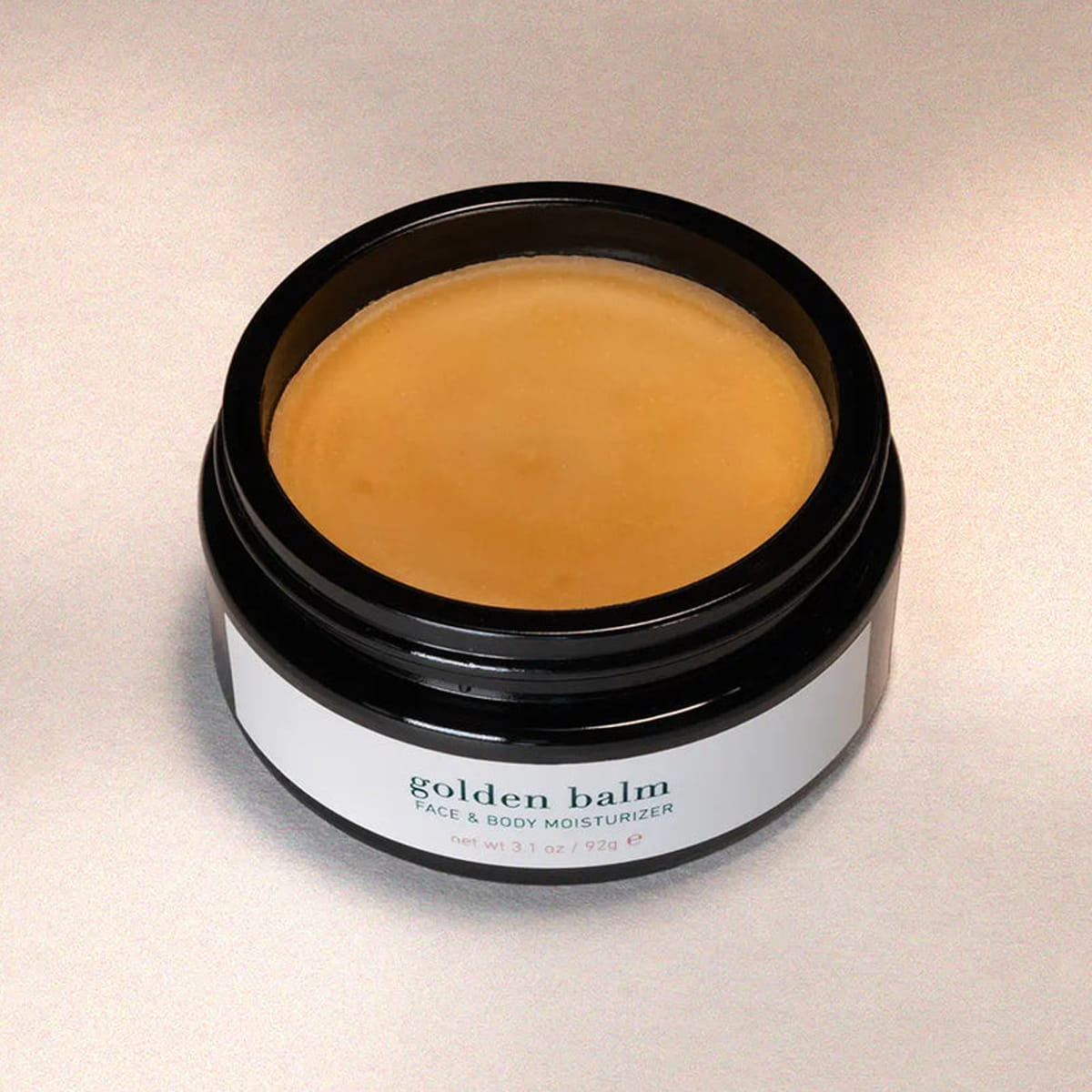 ISUN Golden Balm Face & Body Moisturizer (92 g) shown with lid off and color and texture of moisturizer inside