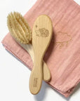 Barnabe Aime Le Cafe Wooden Baby Hair Brush – Hedgehog - Product displayed on pink quilted towel