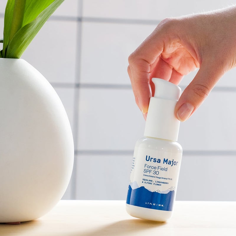 Ursa Major Force Field SPF 30 - Model shown picking up product from counter